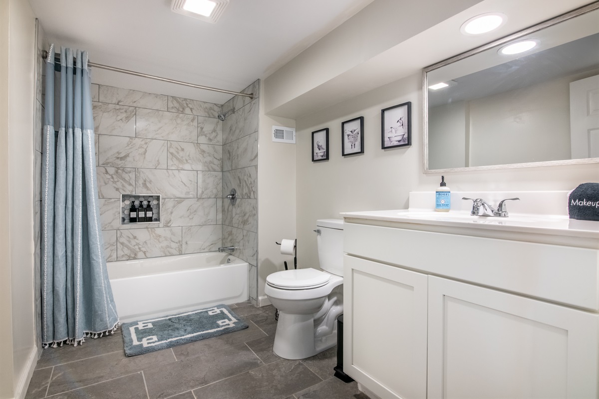 A sparkling clean bathroom with a full tub and fresh modern finishes