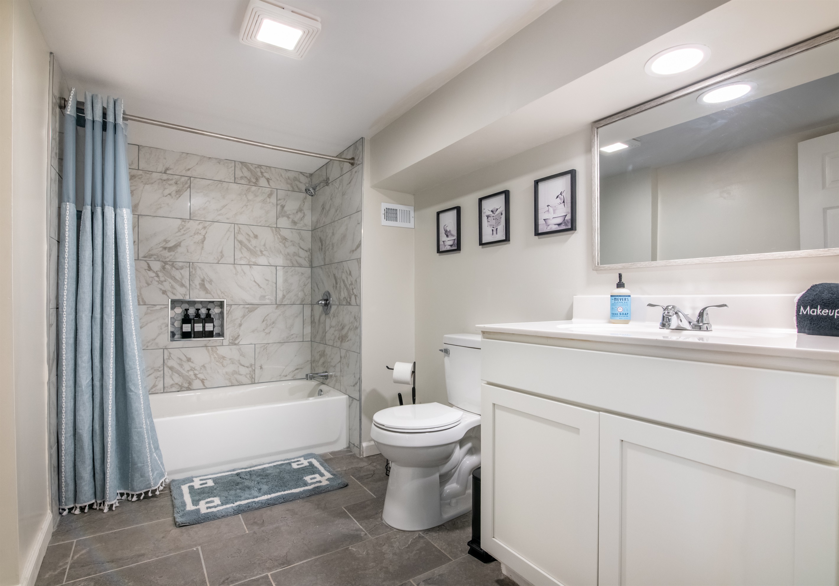 A sparkling clean bathroom with a full tub and fresh modern finishes