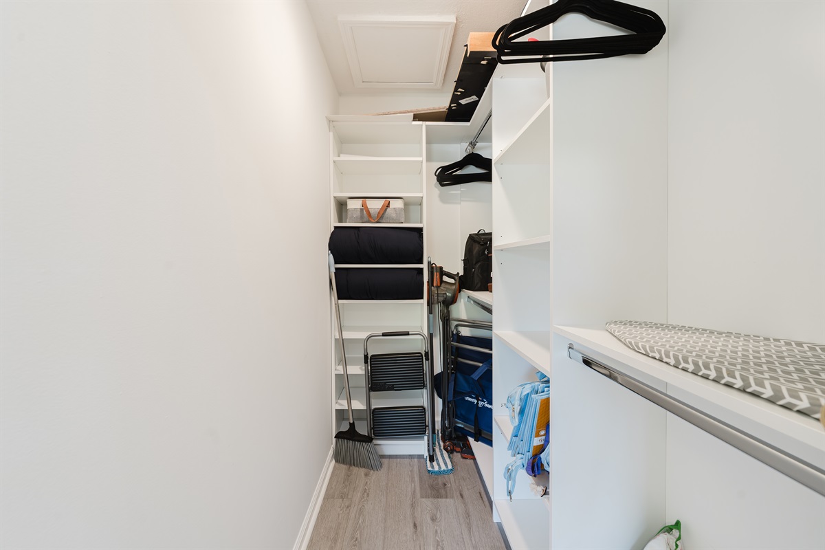 Guest bedroom closet with built-in shelving, hanging space, and extra storage for luggage, beach gear, and longer stays