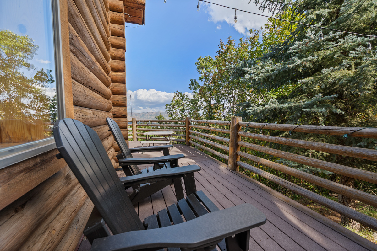 chairs along the wraparound deck offer a quiet place to enjoy the wooded setting.