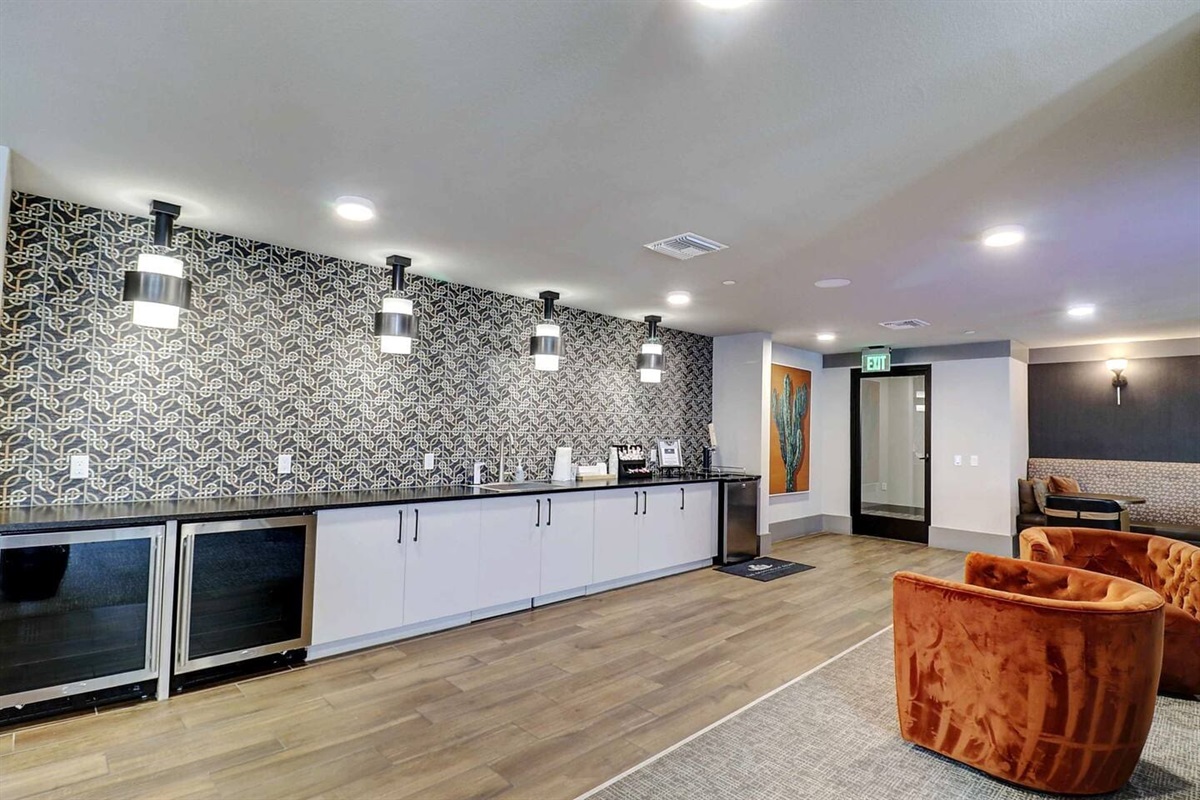 - Relax in the stylish clubroom with a long bar counter and cozy lounge chairs   - Enjoy complimentary coffee, modern lighting, and a chic patterned backdrop   - Great for casual chats, social meetups, or productive workspace sessions