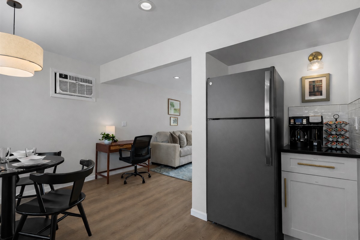 Open kitchen and dining layout with modern appliances, coffee station, and easy flow into the living and workspace areas for everyday comfort.