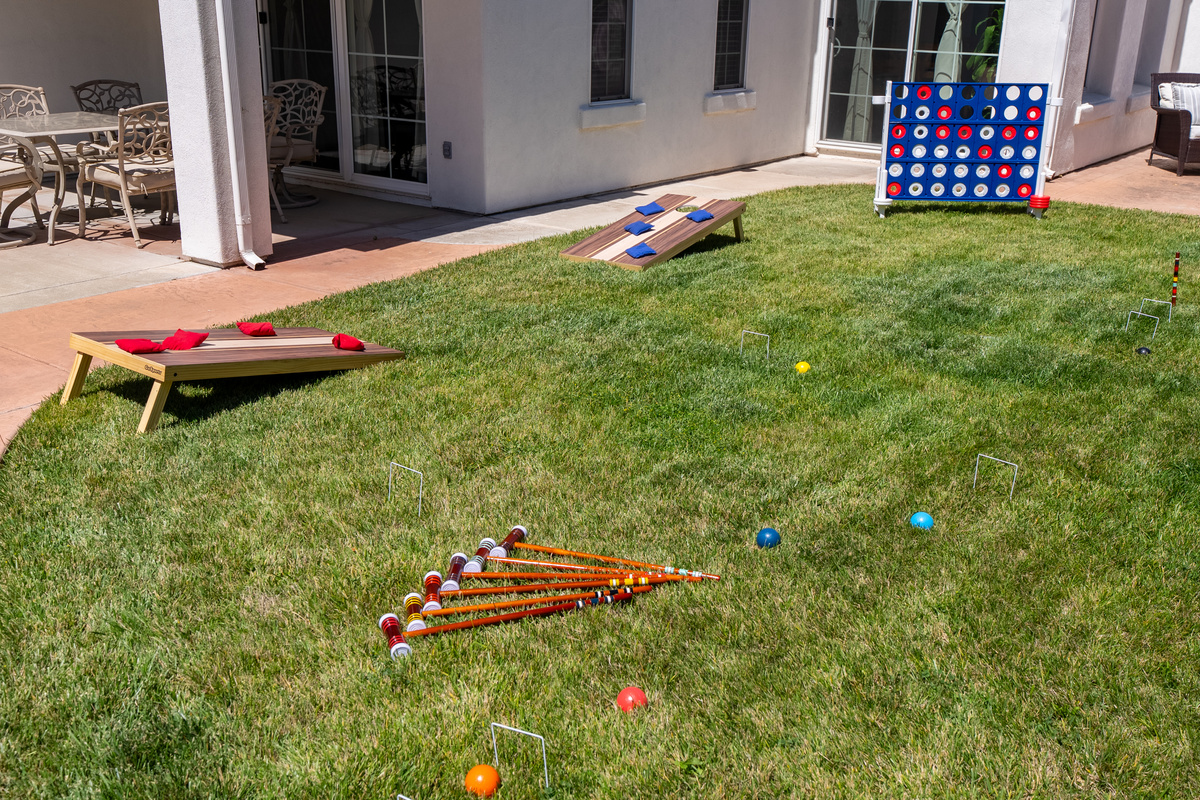 Enjoy a collection of lawn games in the backyard.