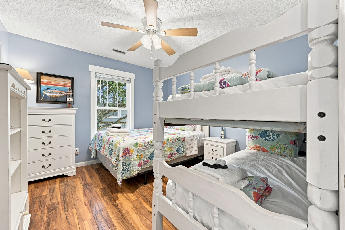 Perfect for families, this spacious bedroom features a queen bed and twin-over-twin bunk beds with room for everyone to relax