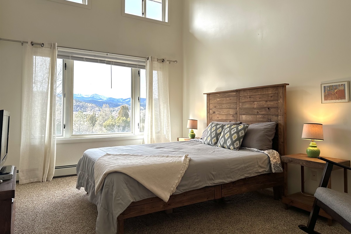 The middle queen bedroom has a TV with DVD player (DVDs provided) and goreous views of the Highland Mountains.