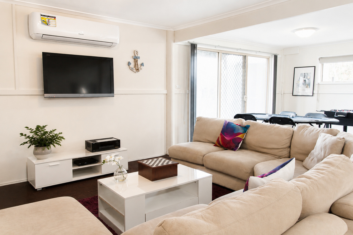 Settle into the downstairs lounge at Carlenes Getaway, with reverse-cycle comfort, TV time and the games area close by for easy Loch Sport evenings.