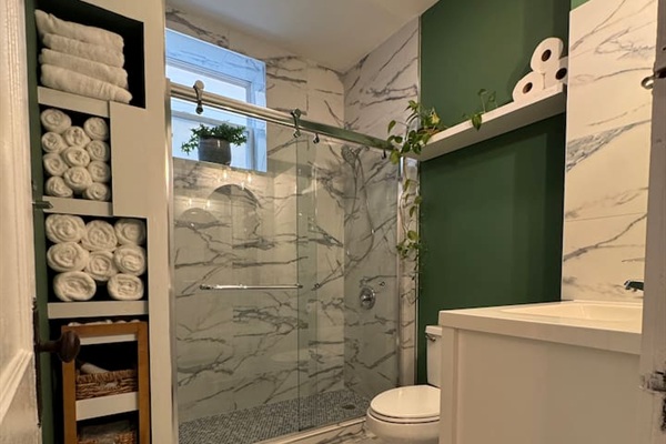 Beautiful bathroom with marble tile designed and modern fixtures.
