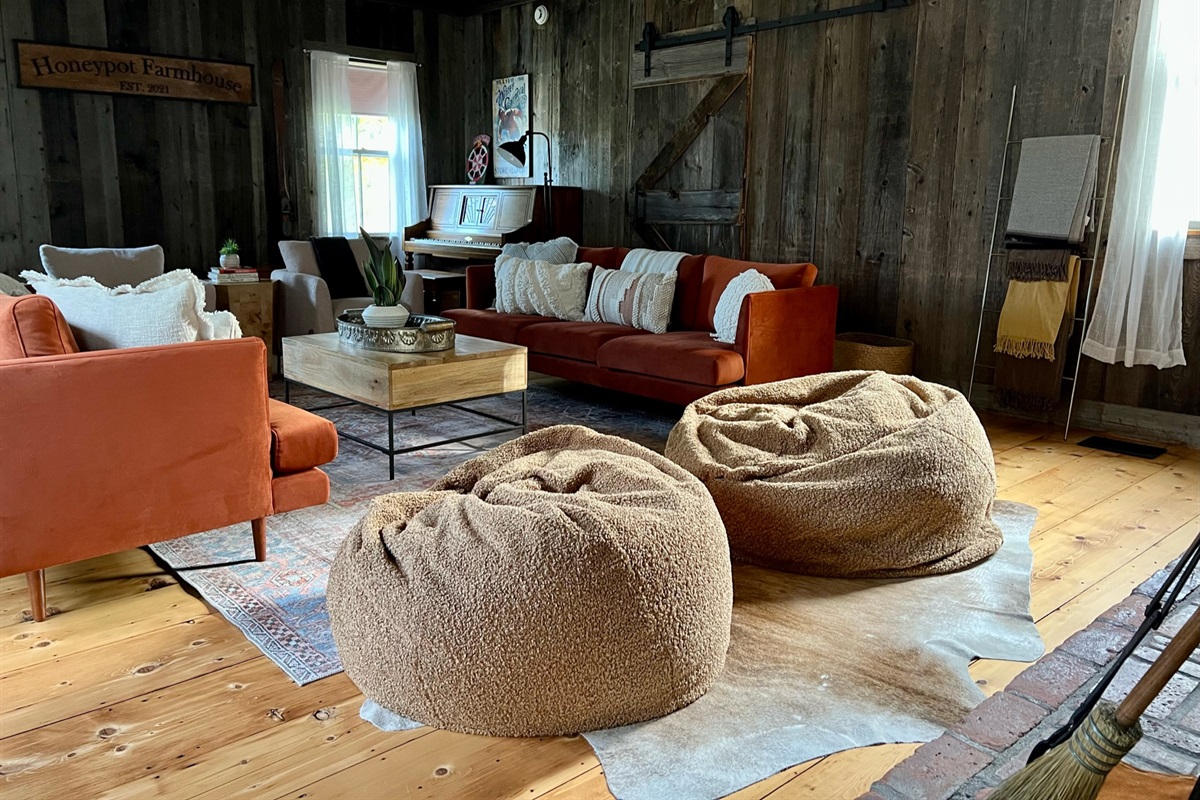 The wood paneling on the Great Room walls used to be the exterior of the barn that sat next to the house from ~1852 until the ~1966. There are 2 photos of the old barn hanging by the fireplace