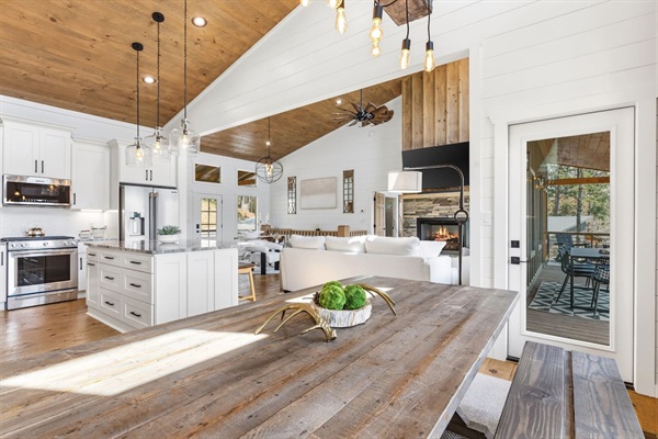 Open to the gourmet kitchen and living room with fireplace, this 8-person rustic farmhouse table is the heart of the home. Perfect for memorable family meals, game nights and effortless entertaining. Three extra stools at the island for more seating.