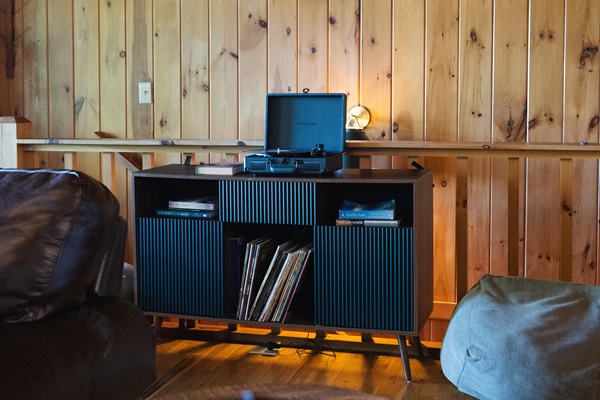 A record player adds a nostalgic touch set the tone with soft music and unwind in true mountain cabin style.