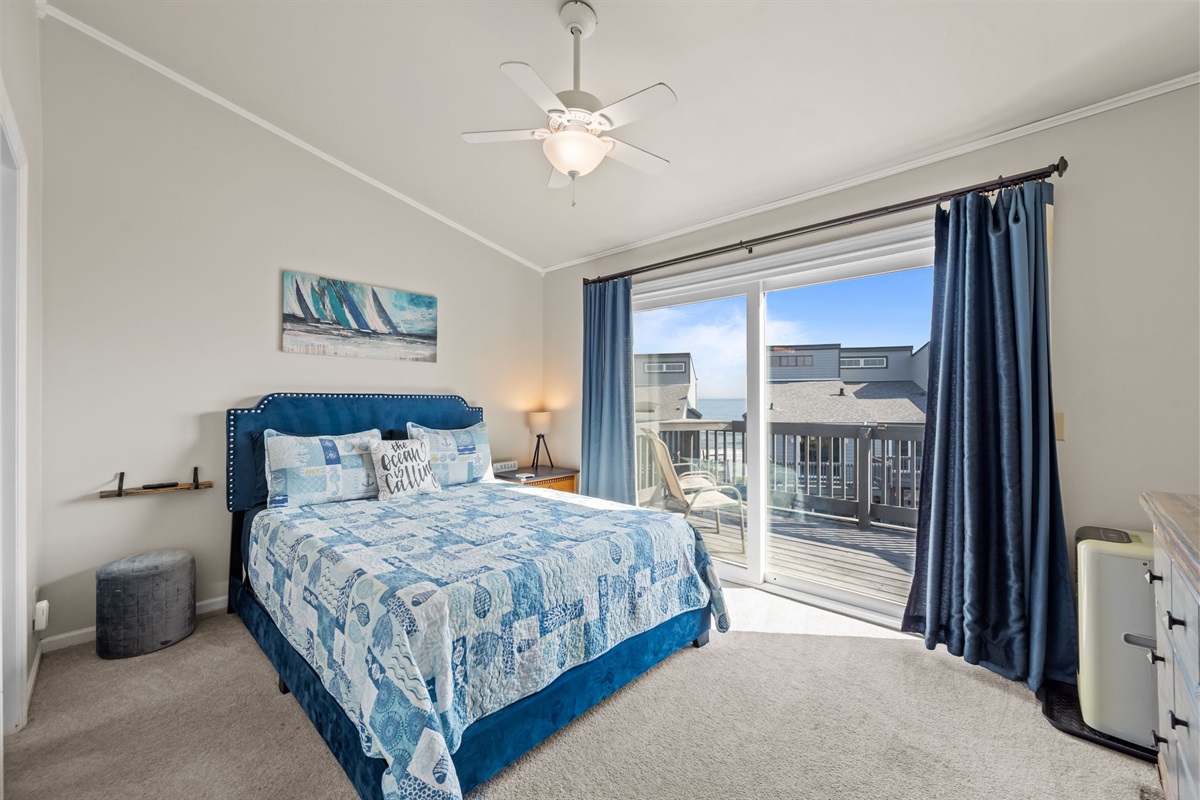 Wake up to ocean views from the private balcony just outside this bright and airy master bedroom