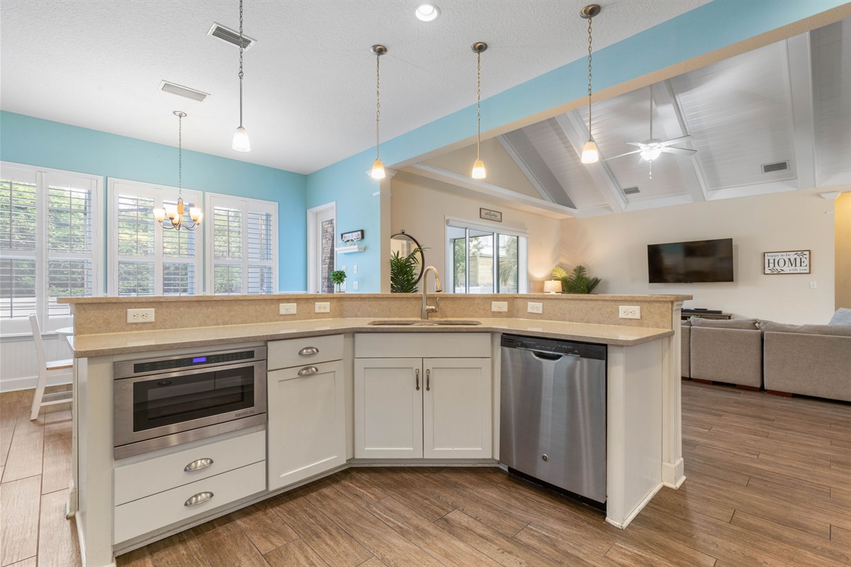 Pour the coffee, map out your beach day, and keep the conversation going from kitchen to living room—this open, airy space lets everyone cook, snack, and stay connected while vacation unfolds around you.