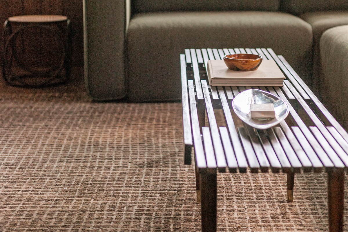 The living room’s coffee table sits perfectly in front of the sofa, inviting you to put your feet up, get comfortable, and enjoy your favorite shows on the TV.