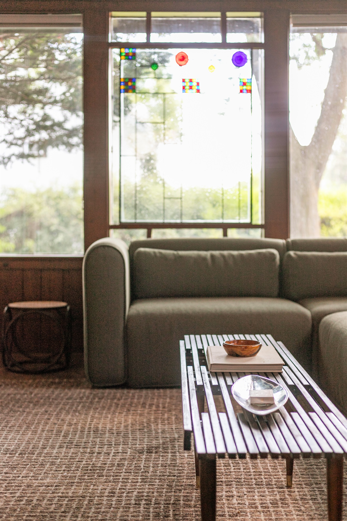 The living room’s coffee table sits perfectly in front of the sofa, inviting you to put your feet up, get comfortable, and enjoy your favorite shows on the TV.