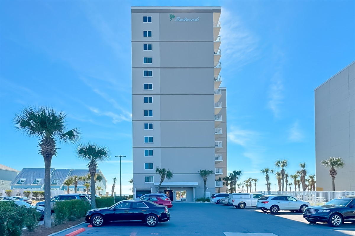Soaring architecture against a backdrop of clear blue skies and swaying palm trees. Experience the allure of beachfront living.