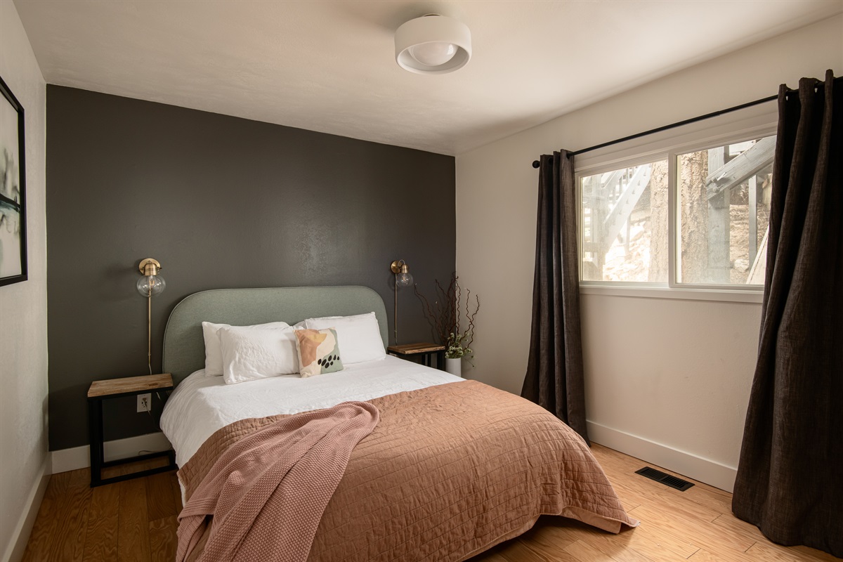Cozy bedroom with comfortable bed and soft natural light—perfect for restful nights during your Lake Arrowhead cabin getaway.
