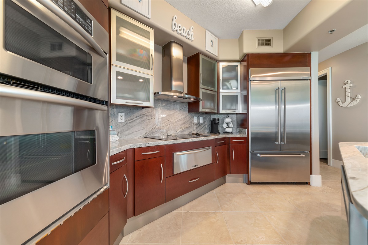 This well-designed kitchen boasts rich wood cabinetry, granite countertops, and stainless steel accents. The open layout ensures a seamless transition to the living and dining areas, creating a perfect space for gatherings.