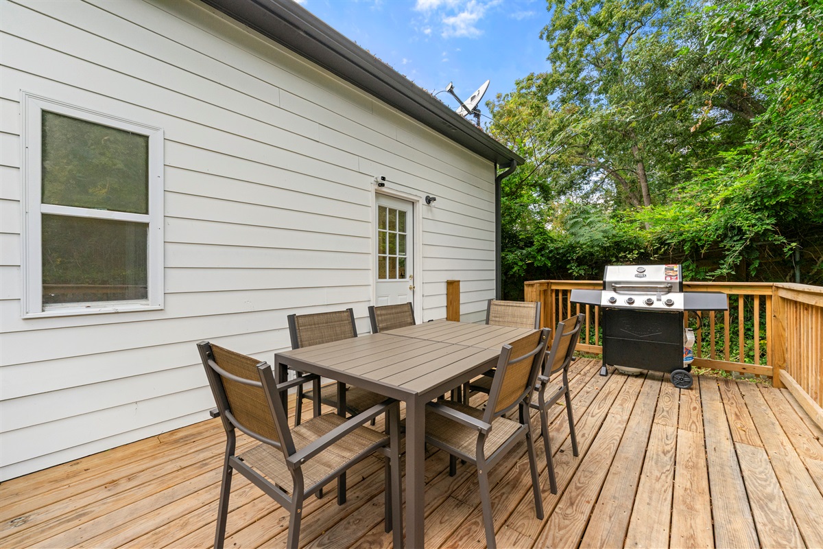 Dine outdoors on the spacious deck surrounded by greenery and fresh air.