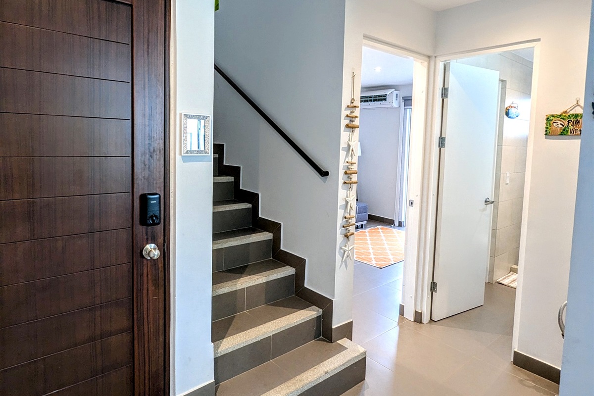 The entrance to the home and stairs leading to the other 3 bedrooms