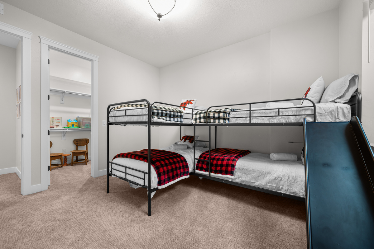 Perfect for families, this spacious bunk room comfortably sleeps four and includes a play area just outside the door.