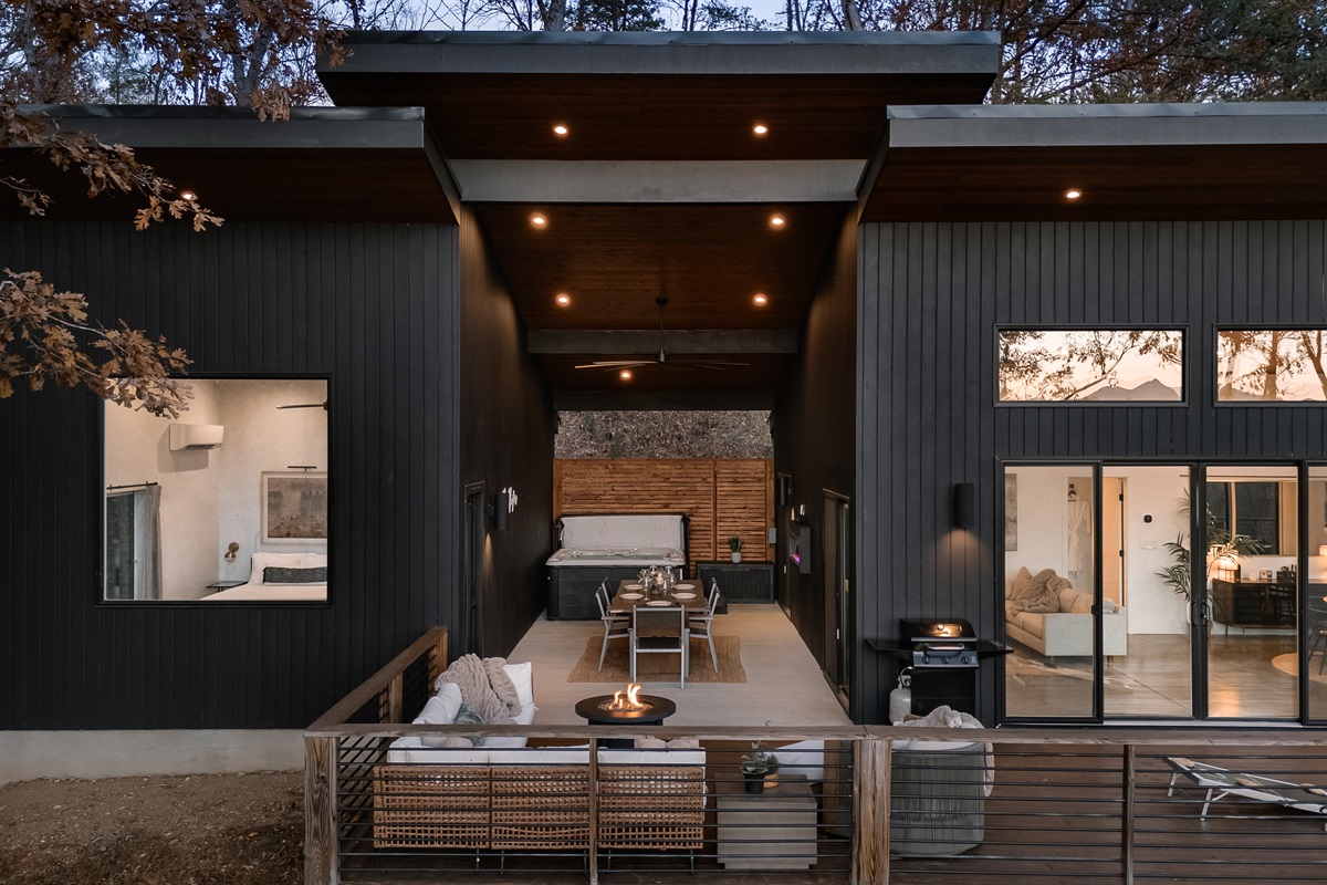{Deck View} A glowing modern retreat—hot tub, breezeway, and architectural lines shining into the night.