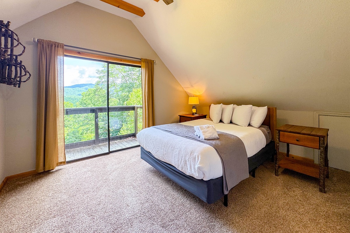 The front upper eave bedroom features a queen memory foam hybrid bed with shredded bamboo pillows. Did I mention the views! There is a private Juliet balcony off this room.