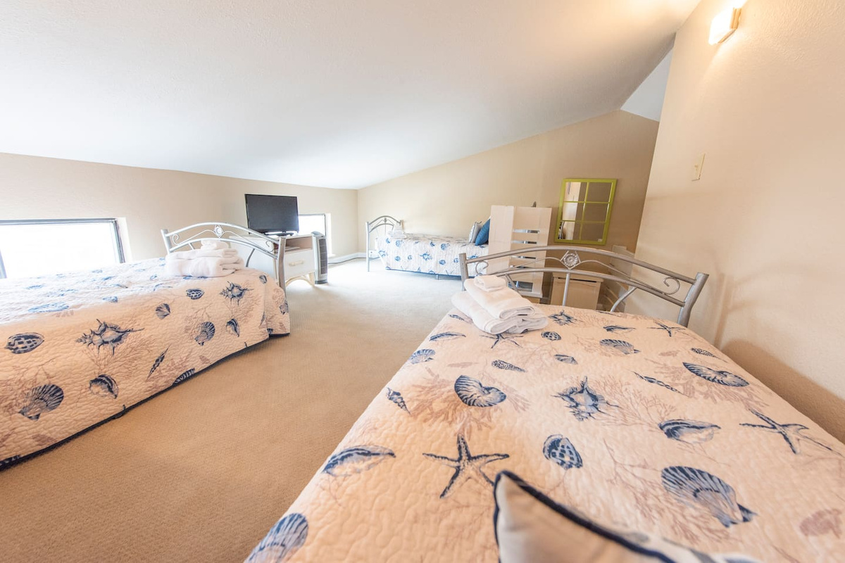 Head upstairs and give the kids the whole loft &mdash; three beds,  a flat- screen TV,  and a floor between them and the adults.