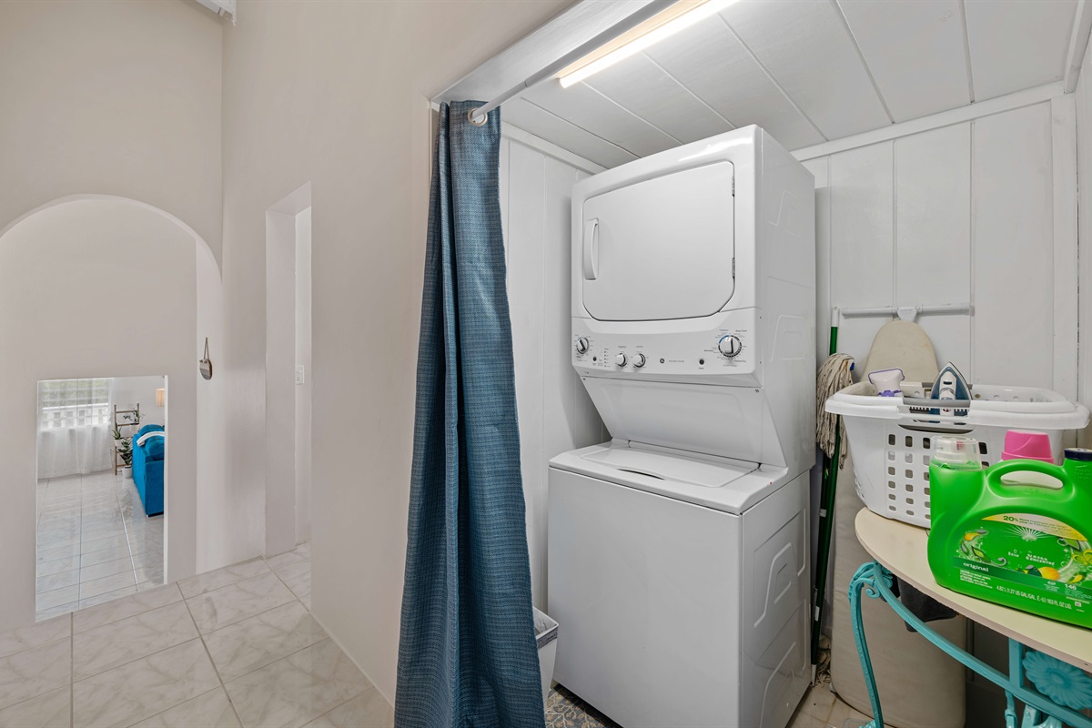 Washer and dryer for your use with an iron, ironing board, and steamer.