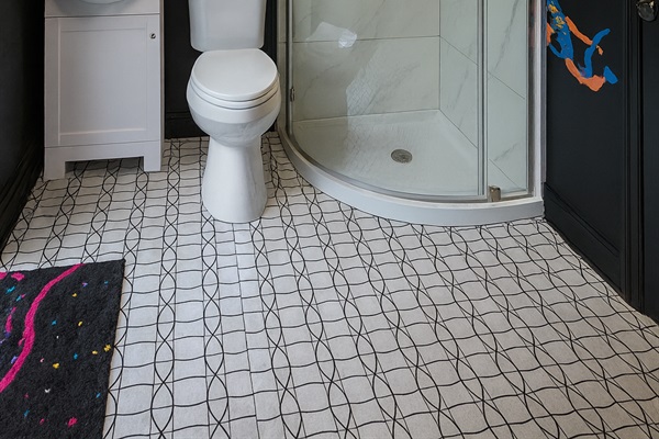 Unique patterned floors and corner shower with charm