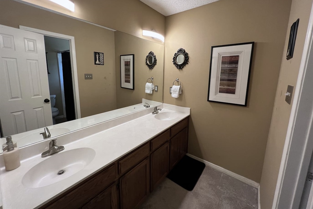 The Hall Bath features a double sink vanity.  Shower Room Adjoins.  Towels, Soaps and Toilet Paper Provided.
