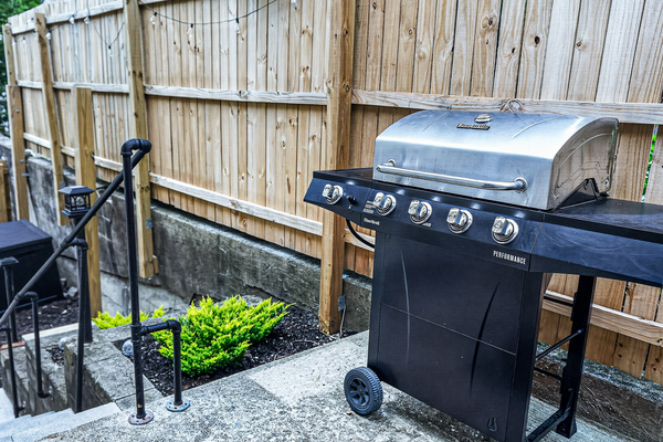 Gas grill and steps to hot tub patio.