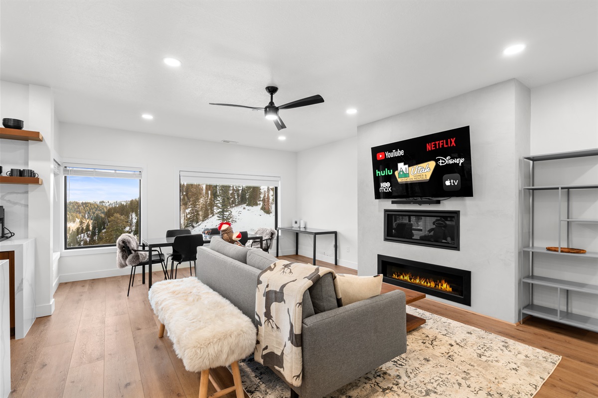 Open-concept living space filled with natural light and mountain scenery.