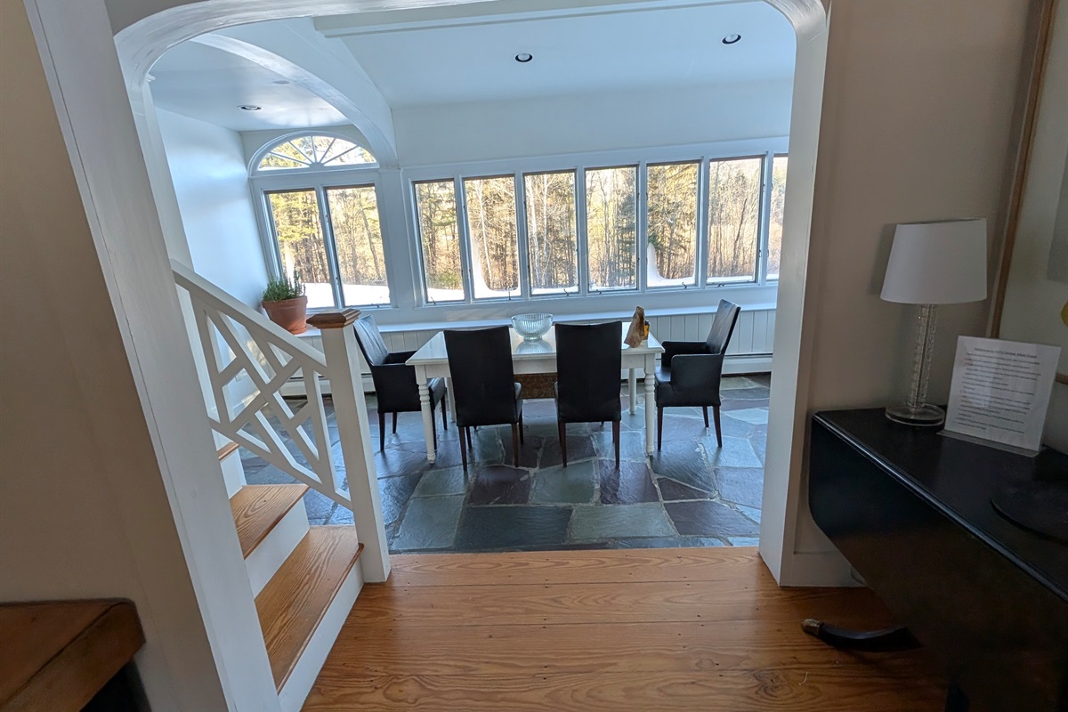 Step into a light-filled dining space where walls of windows bring the outdoors in.