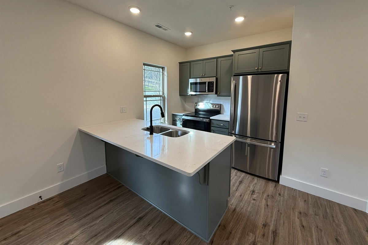 Gourmet kitchen stocked cooking meals together