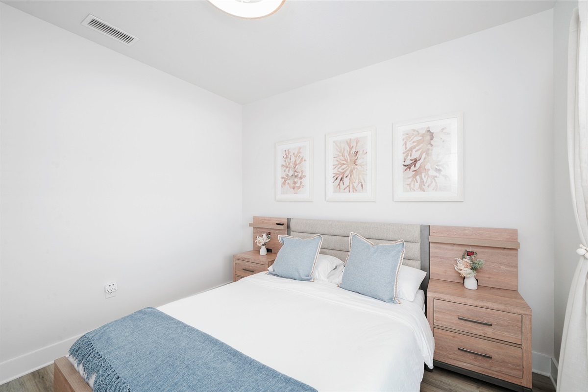 Bedroom 2: Bright Queen bedroom, comfy linens, ceiling fan, elegant bedside lamps, wall art, and Smart TV.