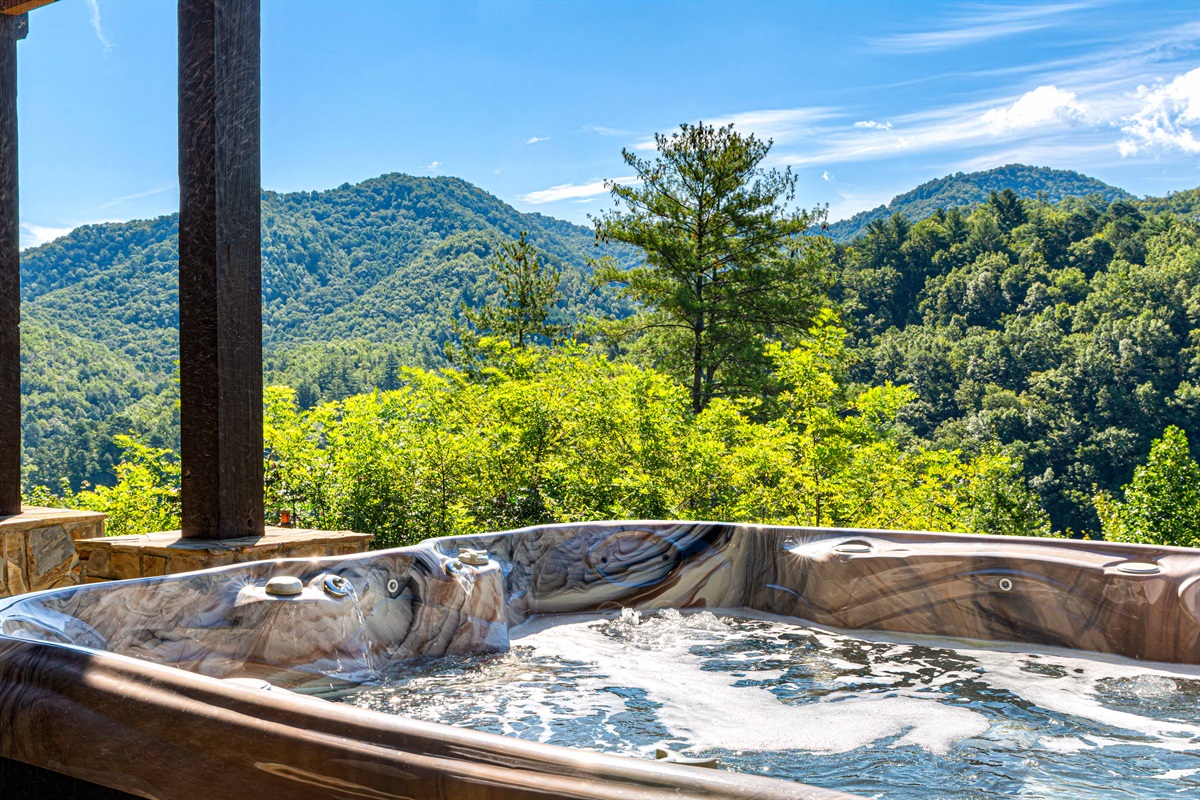 Outdoor Spa Oasis: Relax in a bubbling hot tub with stunning mountain views just outside your door!