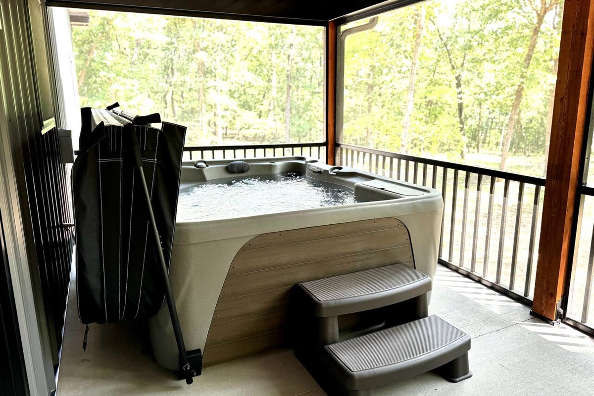 UNHOOK all four hot tub lid clasps and fold the cover OVER the metal bar. Lift the metal bar to suspend the hot tub lid conveniently in place. We are happy to go over the hot tub functions in person with you when you check-in.