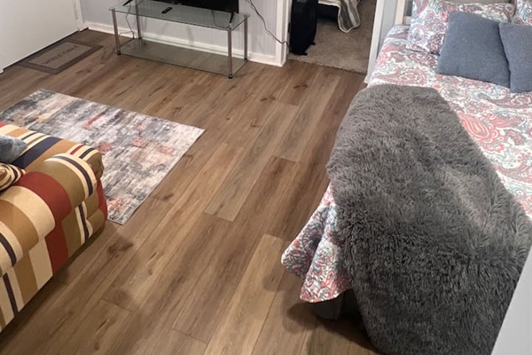 The third bedroom is a converted common area that has been set up as a comfortable sleeping space. While it does not have a traditional enclosed bedroom layout, it provides a cozy and functional area ideal for additional guests. 