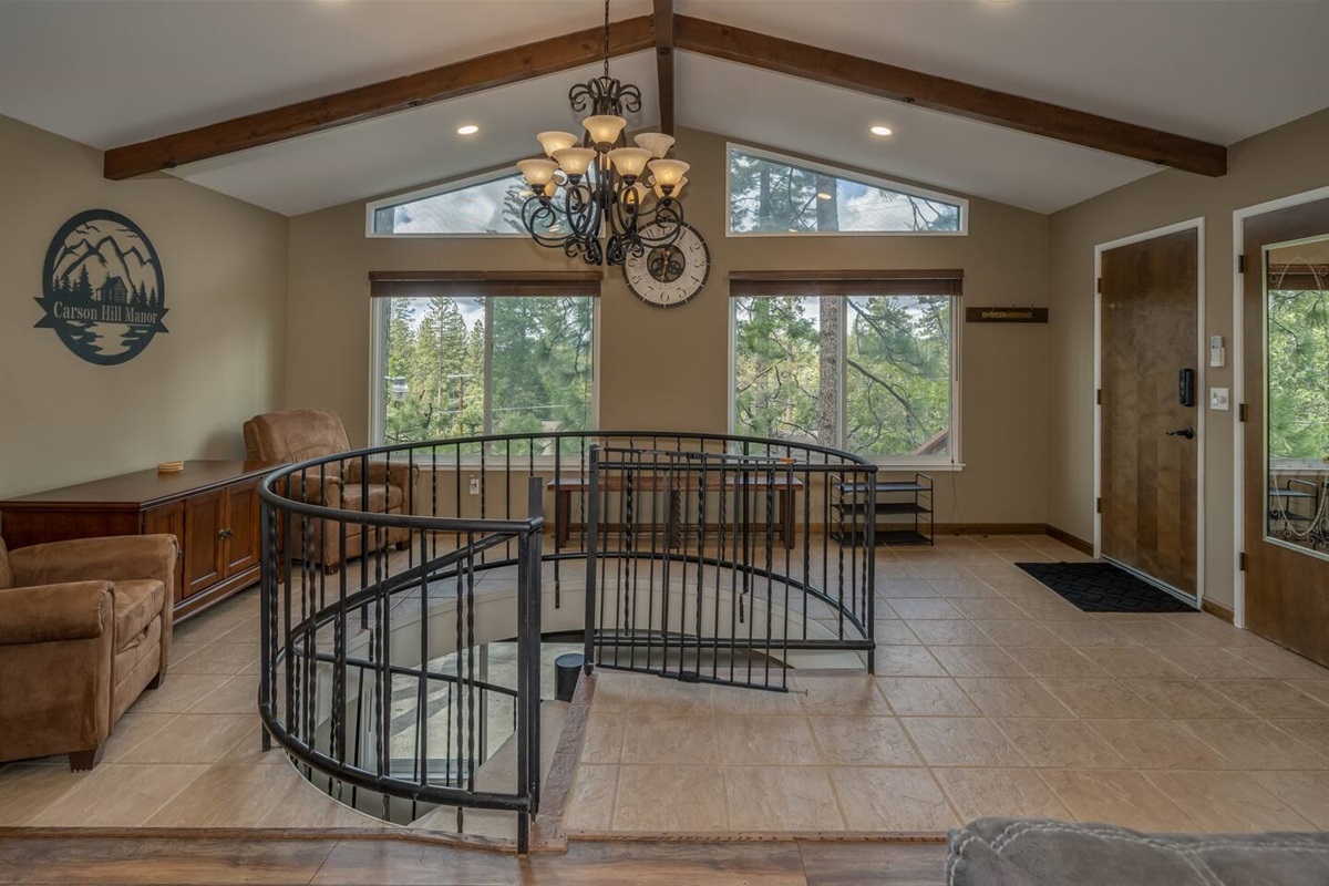 Bright and airy entry way. Beautiful spiral staircase with baby gate located at the top. Also has two massage chairs for you to relax and take in the view. 