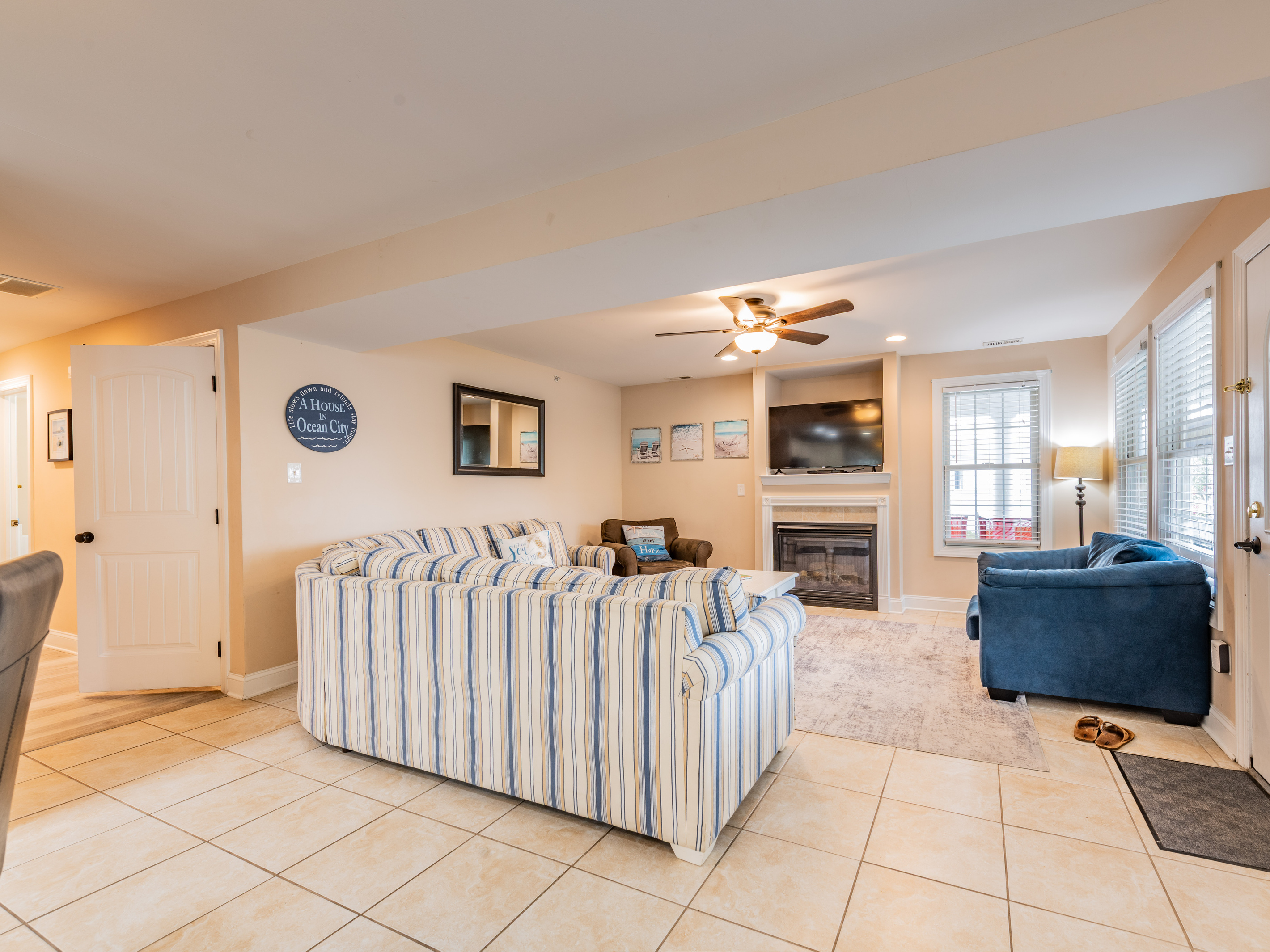 Living Room Area with Striped Sectional and Mounted Flat-Screen TV
