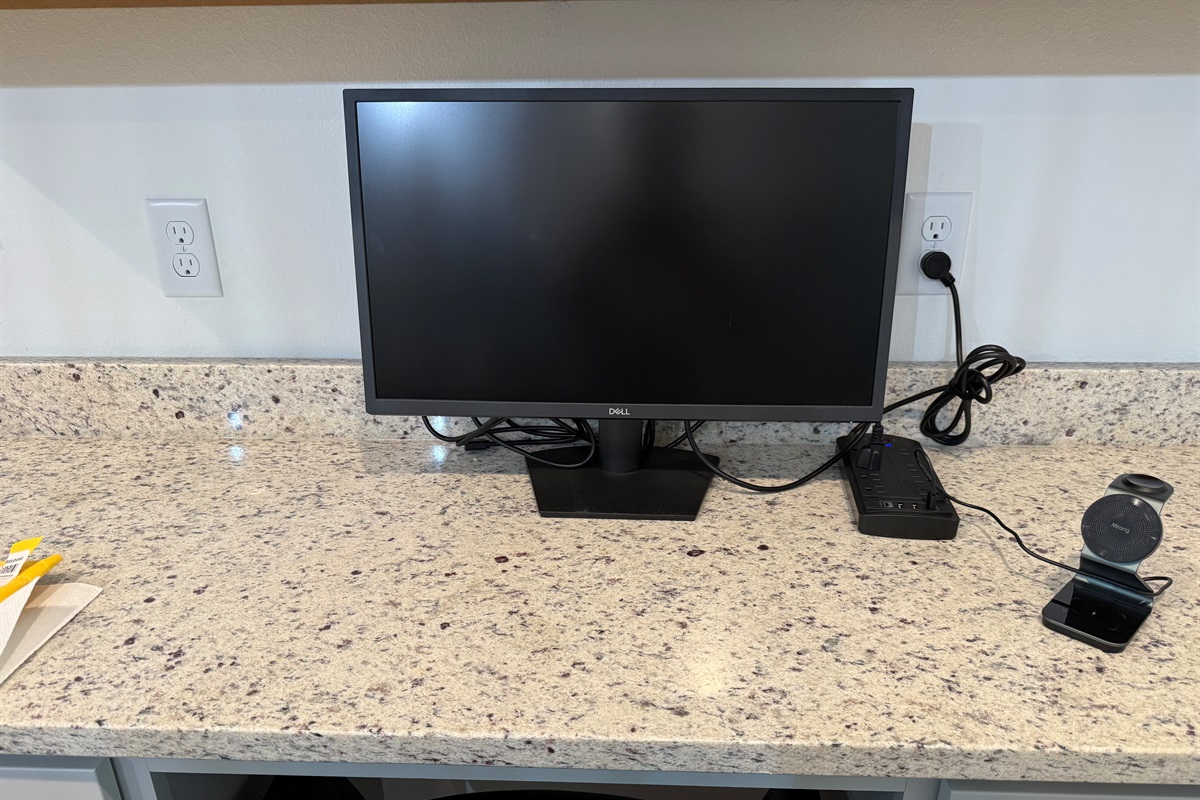 Monitor, phone charger and surge protector for your computing needs.