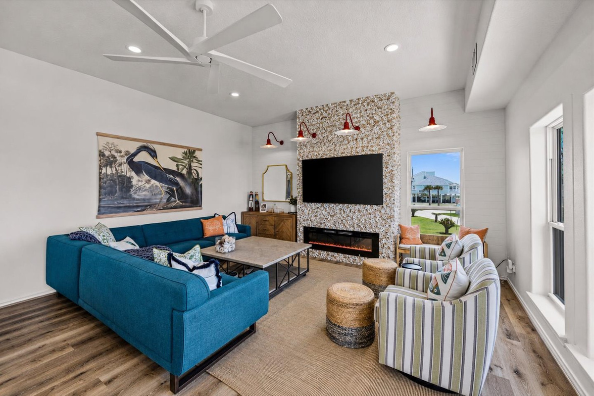 Several seats several to enjoy the 75" TV, electric fireplace, and bar at the corner console. The oyster shell wall is a work in progress - it is not completed. 