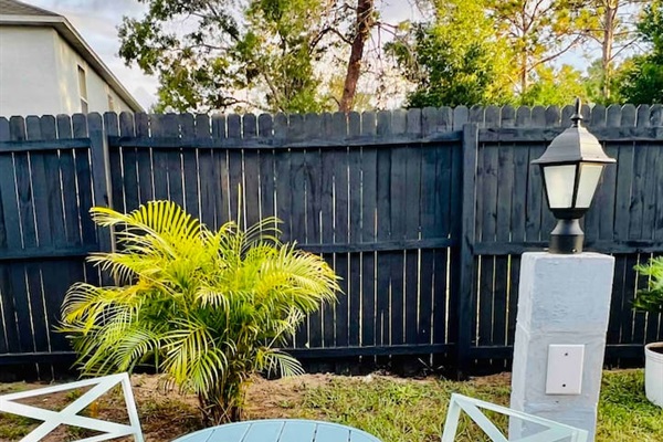 Outdoor seating area with bistro set. This is the designated smoking area as smoking inside the house or the lanai area is not permitted 