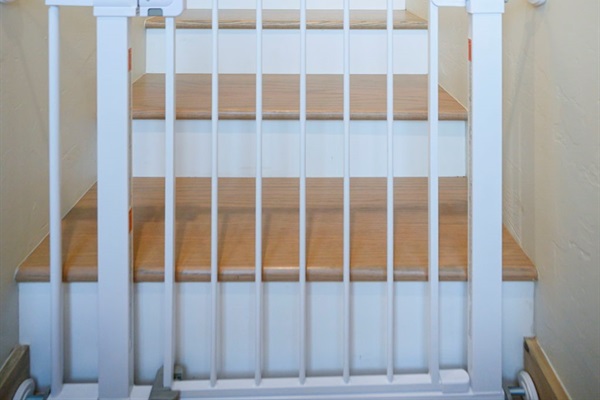 Stair safety gate installed &mdash; peace of mind for families with toddlers.
