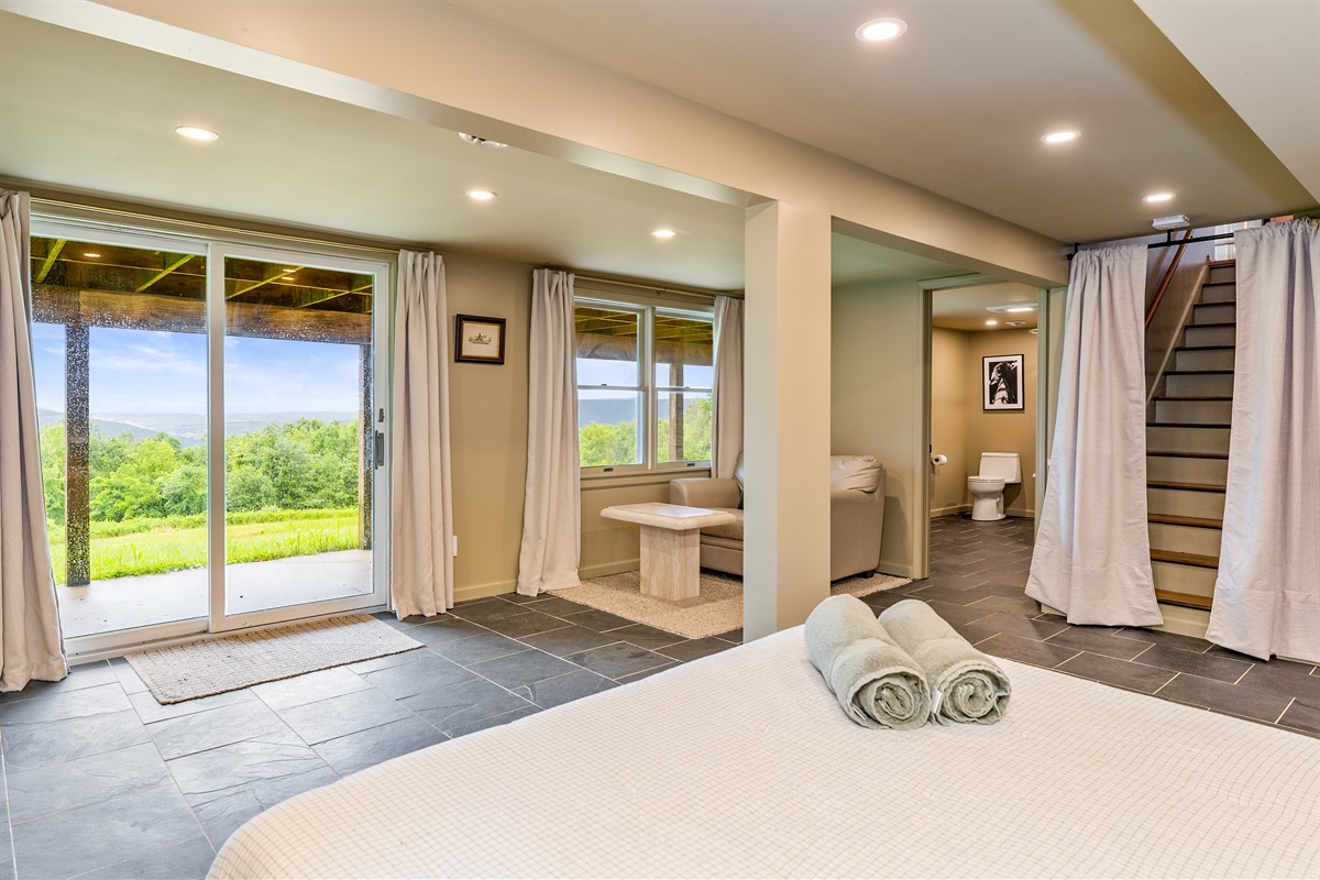 Wake up to stunning views from this walkout lower level bedroom suite with private sitting area and patio access.