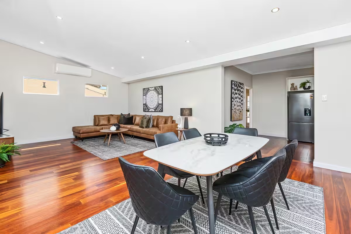 The six-person dining table gives Sasha’s Cottage on the Hill a practical shared space beside the lounge and kitchen.