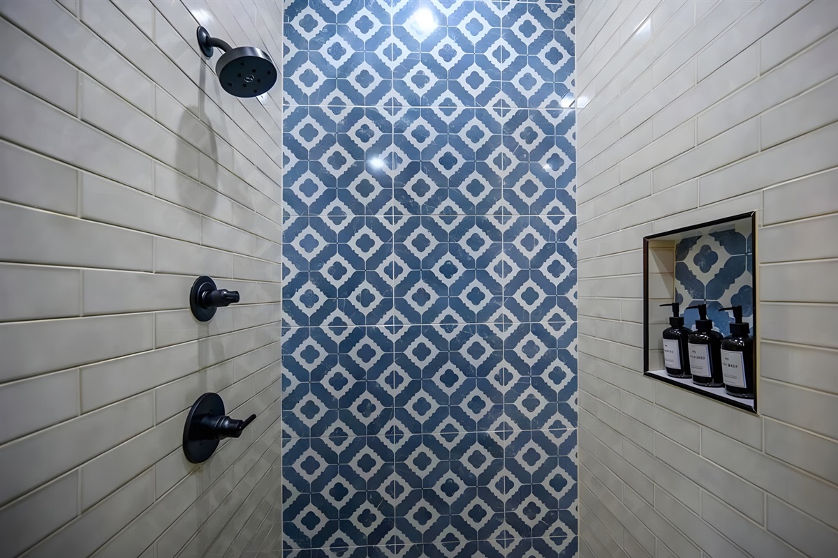 The patterned tile in the shower adds just the right amount of personality to this clean and stylish space.
