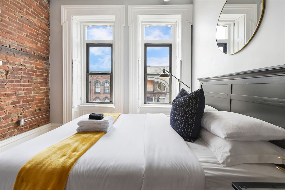 Spacious and elegant queen-sized bedroom with TV designed for comfort and style.