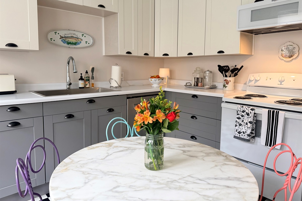 Fully equipped kitchen featuring modern stainless sink, ample counter space and generous cabinetry. 
