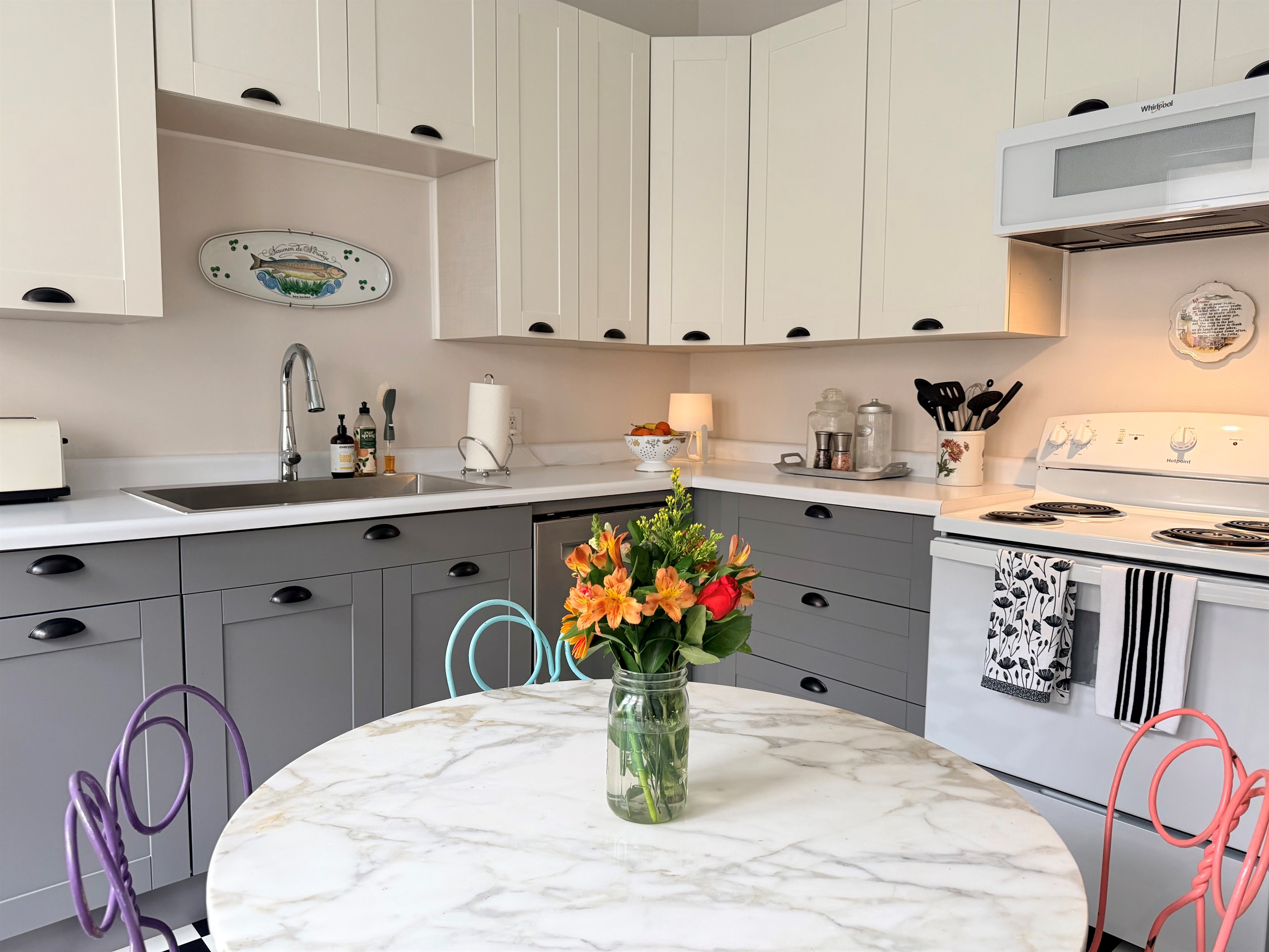 Fully equipped kitchen featuring modern stainless sink, ample counter space and generous cabinetry. 